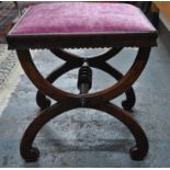 A Victorian rosewood cross-frame dressing stool with fabric seat,