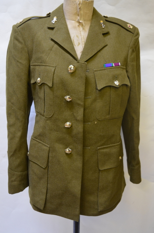 An army uniform with two shirts and braces and two kit bags