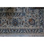 A large Persian Nain carpet, the flowering vine design on traditional off white/camel ground,