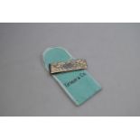 A Tiffany & Co money clip with engraved front stamped Sterling Tiffany & Co to/w pouch and box