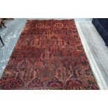 A Persian Baktiari rug, the pale red/pink ground with palmette tile design,