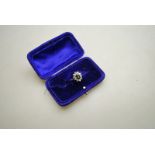 An oval dark sapphire and diamond cluster ring, white metal set stamped 18ct,