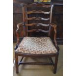 A George III mahogany framed wavy back elbow chair with upholstered seat pad raised on square legs