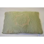 A 1940s pale green satin feather filled, quilted pillow,