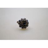 A sapphire set domed flower cluster ring,