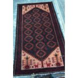 A Turkish long rug, the field of repeating geometric guls on red-brown ground,