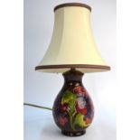 A Moorcroft contemporary table lamp, brown ground decorated with orchids, c/w shade,