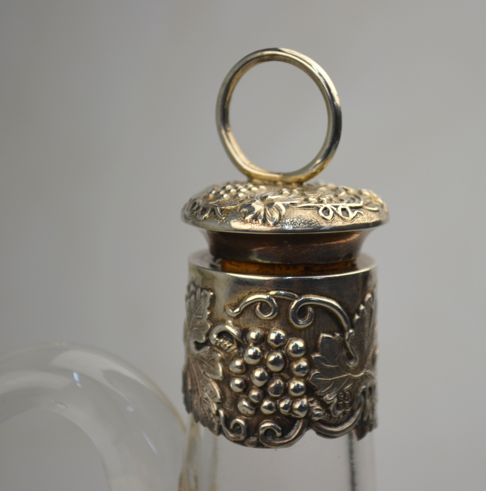 A Victorian glass wine bottle with wheel-etched vine decoration and vine-embossed silver collar and - Image 2 of 4