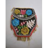 A Native American, bead decorated red textile purse,