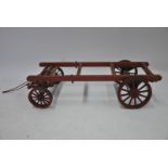 A model gipsy caravan sub-frame with cast metal wheels,