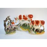 Two Victorian Staffordshire models of cows each with a calf beside a stream,