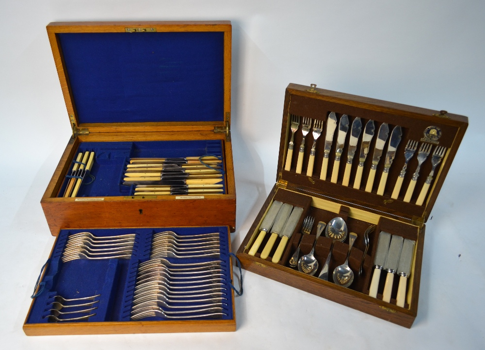 An Edwardian period oak canteen containing an extensive part set of OEP electroplated flatware for