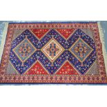 An Ardabil design machined rug, the triple multi-coloured geometric pole design on red/blue ground,