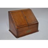 A late 19th/20th century oak slope front stationery cabinet,