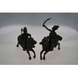 A pair of African sand-cast bronze figures of mounted soldiers,