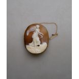 An oval shell cameo in high relief featuring classical scene in yellow gold mount stamped 15 with