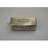 A George III silver fob vinaigrette, the reeded case with shell-chased thumb-piece,