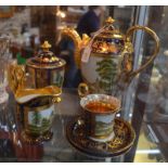 A regal tete a tete porcelain set with gilt decoration and medallions depicting the Royal Chateau