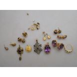 A lot containing a pair of large oval amethyst stud earrings,