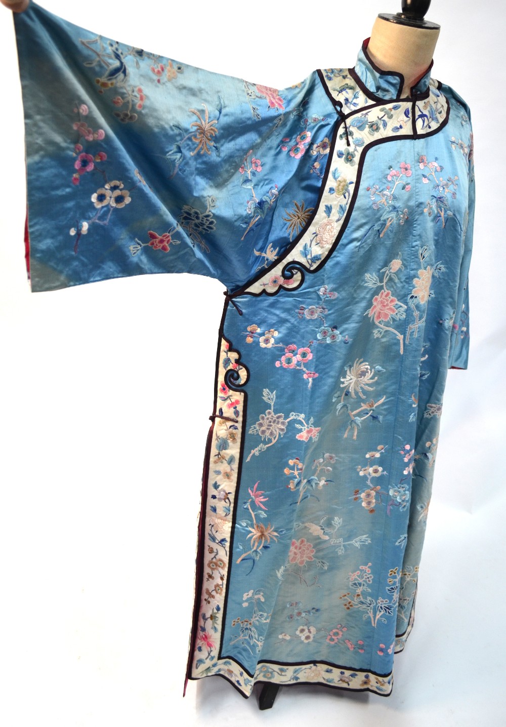 A Chinese blue silk robe embroidered with flowering prunus, japonica and tree peonies, - Image 6 of 8