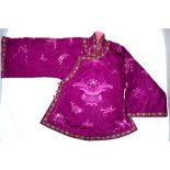 A mauve silk jacket for a child, decorated with floral designs, bats peaches,