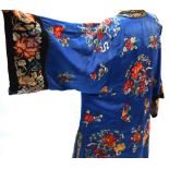 A blue ground Chinese silk coat, decorated with floral designs; the black ground sleeves,