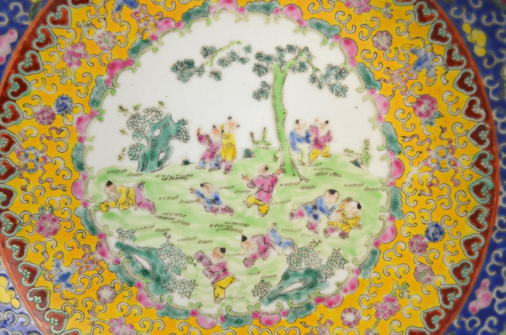 A famille rose dish, decorated with a central design of Manchu/Chinese boys at play; 29. - Image 2 of 5