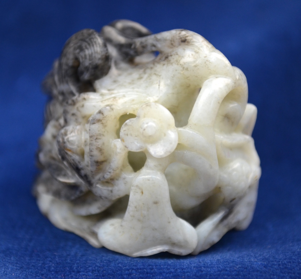A mottled grey, white and black jade hat finial decorated with a Natural History design, 3.