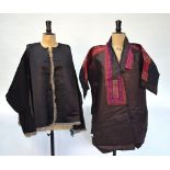 A black ground textile jacket with facings in red, mauve and black,