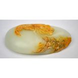 A jade pebble carving designed with a large bird above a peony,