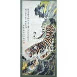 A Chinese textile picture of a tiger beside rocks; three line inscription and red seal;