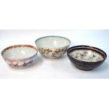 Three famille rose punch bowls: one decorated with Manchu/Chinese figures,