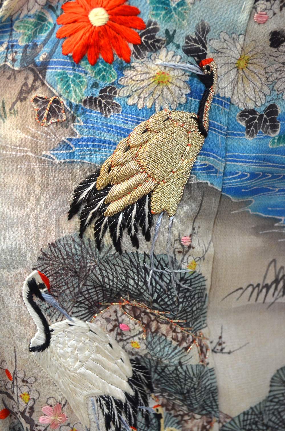 A Chinese blue silk robe embroidered with flowering prunus, japonica and tree peonies, - Image 8 of 8