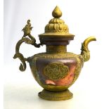 A Tibetan or Himalayan copper kettle with domed cover, knop finial and dragon handle, 33cm high,