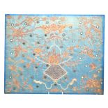 An elegant blue-ground Chinese textile, decorated with a hanging basket design in gilt thread,