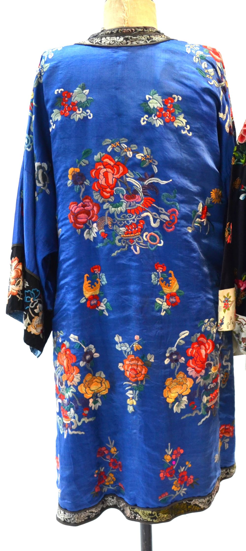 A blue ground Chinese silk coat, decorated with floral designs; the black ground sleeves, - Image 3 of 5