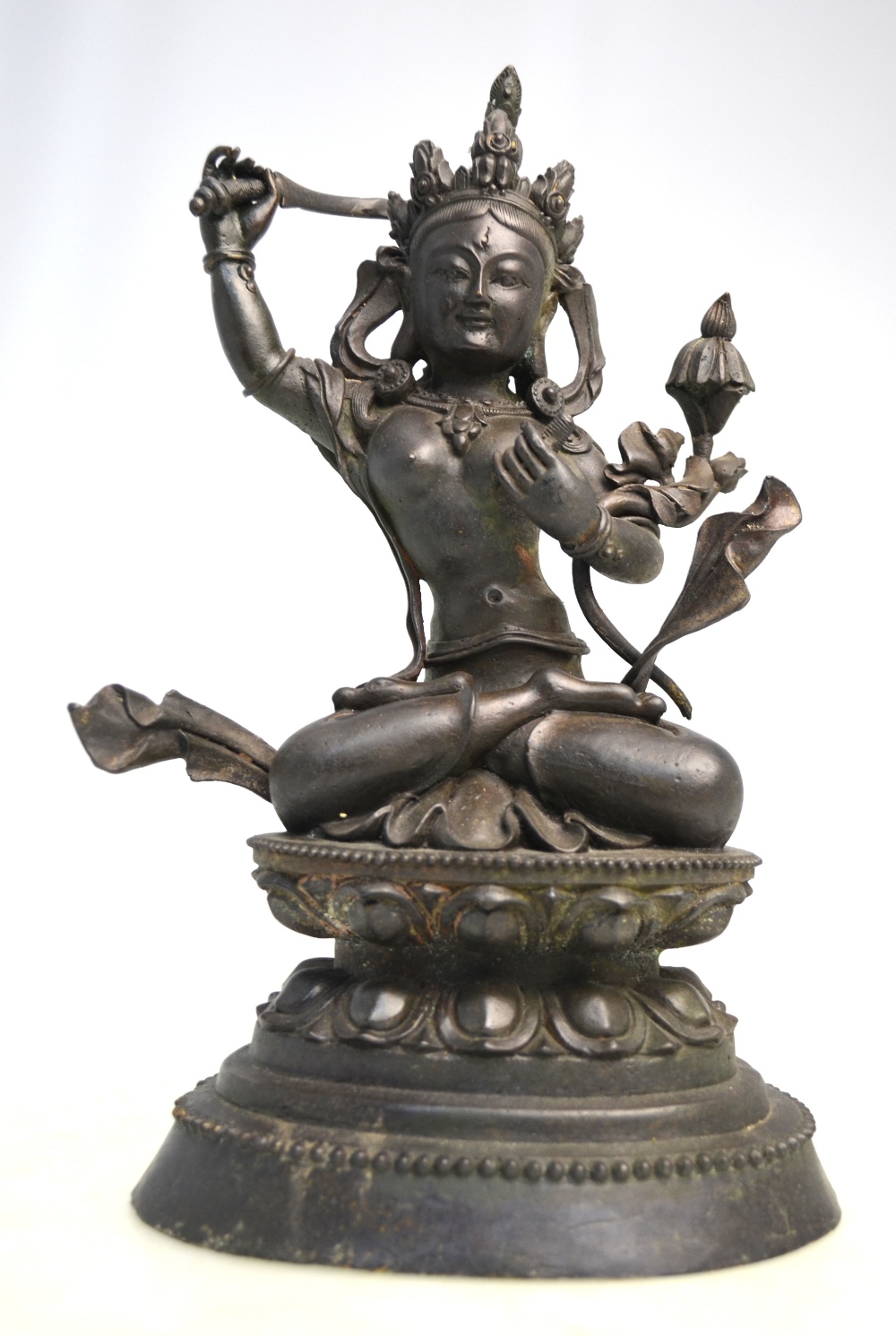 A Tantric figure of a Deity, seated in dhyanasana on a lotus base,