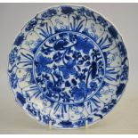 A blue and white dish with central floral design surrounded at the well with alternate panels of