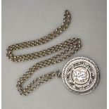 A Chinese white-metal circular pendant with single character on both obverse and reverse;