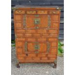 A Chinese rectangular wood chest in two parts with metal fittings,