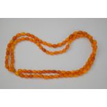 An amber necklace comprising 96 small beads, overall length when hanging about 46cm, approx. 21.