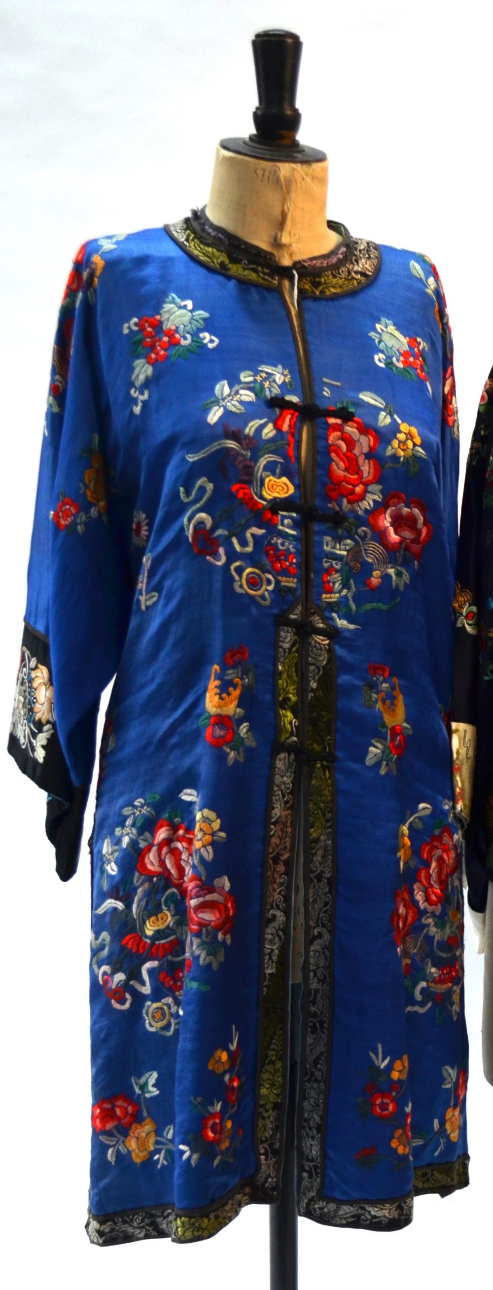 A blue ground Chinese silk coat, decorated with floral designs; the black ground sleeves, - Image 2 of 5