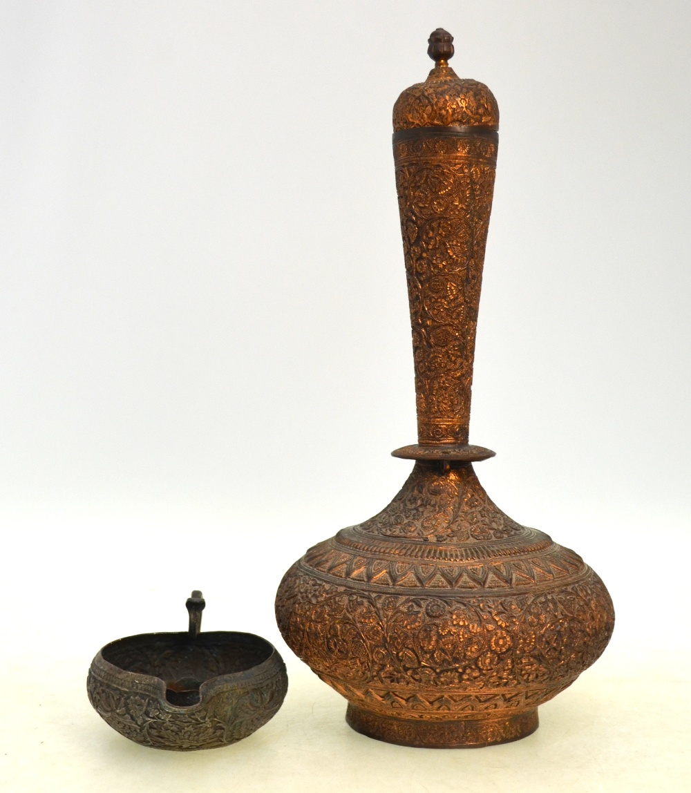 A Qajar, or other, metal-alloy vase with domed cover, decorated with floral designs,