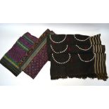 Two textiles from Bhutan; each with mauve field and linear designs with yellow and green designs;