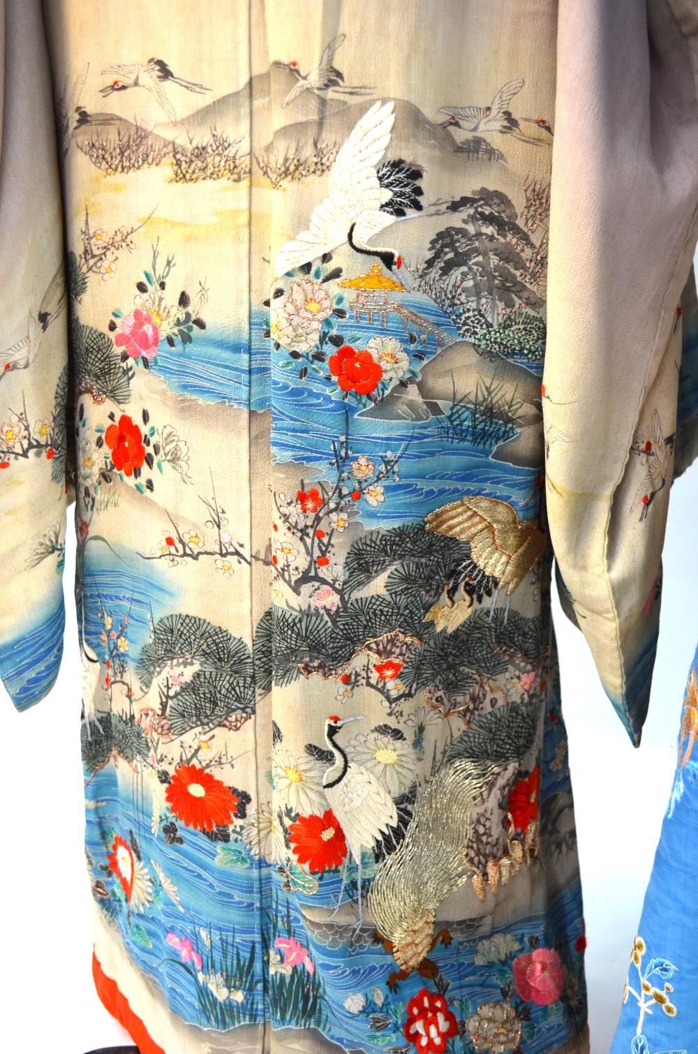 A Chinese blue silk robe embroidered with flowering prunus, japonica and tree peonies, - Image 4 of 8