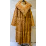 A mid-tan mink full-length coat with fox