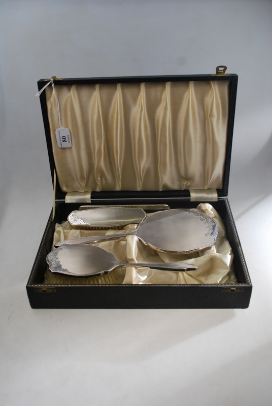 A cased silver four-piece brush set with