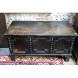 A 17th century oak coffer, the hinged mo