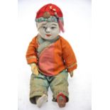 A composite-head Chinese boy doll in traditional costume,