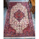 A Persian Ardebil rug, the cream ground centred by a geometric motif,